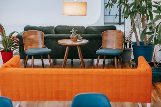 A stylish modern living room featuring wooden furniture and vibrant plants, creating a cozy ambiance.