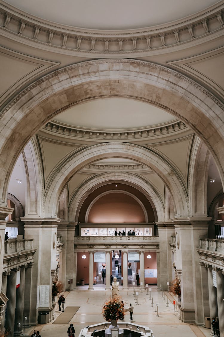 Interior Of Aged Masonry Building With Unrecognizable People In Corridor