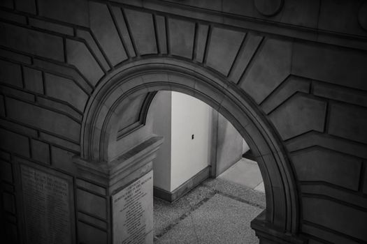 Old masonry building interior with arch above passage