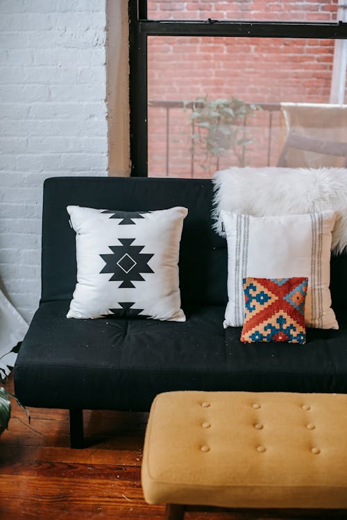 Interior of cozy apartment with sofa and pouf