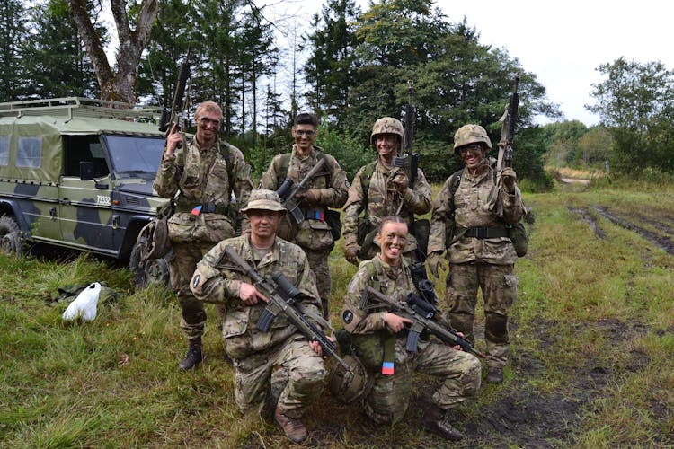 A Group Of Smiling Soldiers  With Rifles