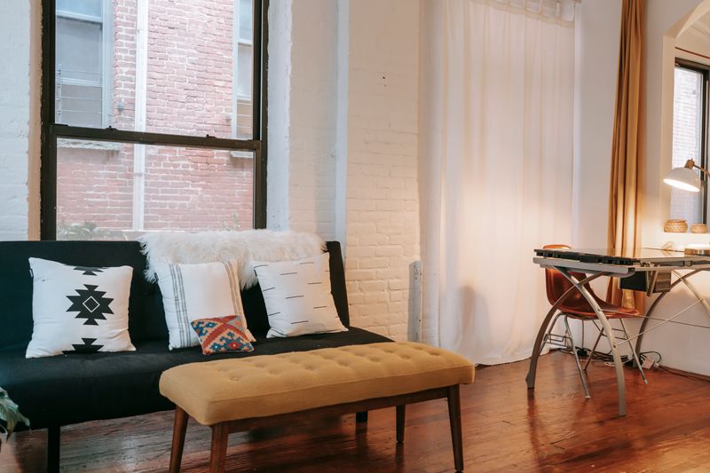 neutral fabric curtain hung as a plain backdrop behind a desk