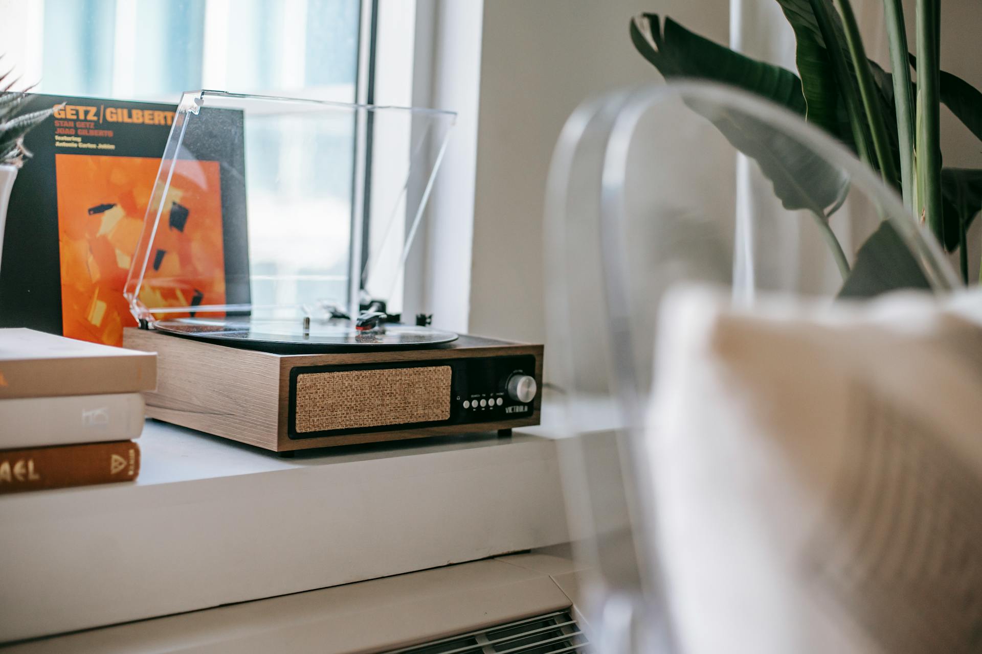 Retro record player on windowsill at home