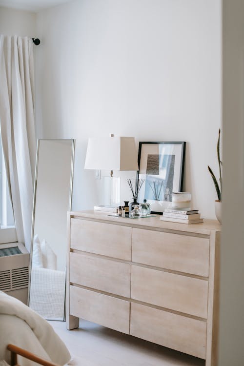 Bedroom interior with commode and mirror in house