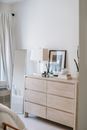 Bedroom interior with commode and mirror in house