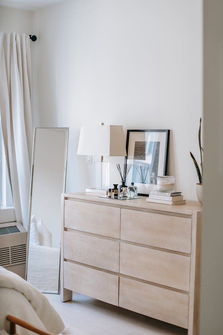 Bedroom Interior With Commode And Mirror In House