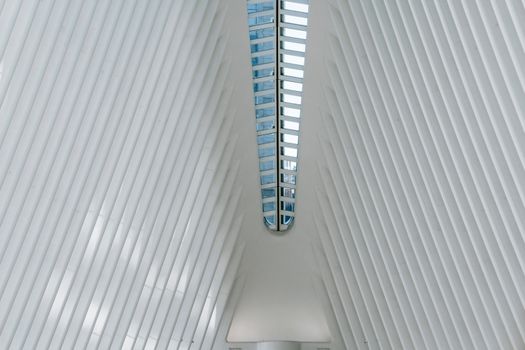 From below of modern house roof with straight vertical and horizontal beams in rows in daylight