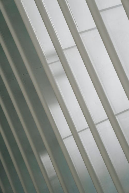 Free Textured backdrop of similar shiny vertical beams with ribbed surface in modern building in daylight Stock Photo