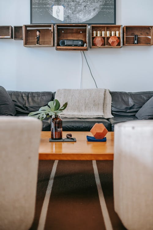 Modern living room interior with wooden table and black sofa