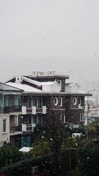 A collection of apartment buildings covered in snow during a winter snowfall.