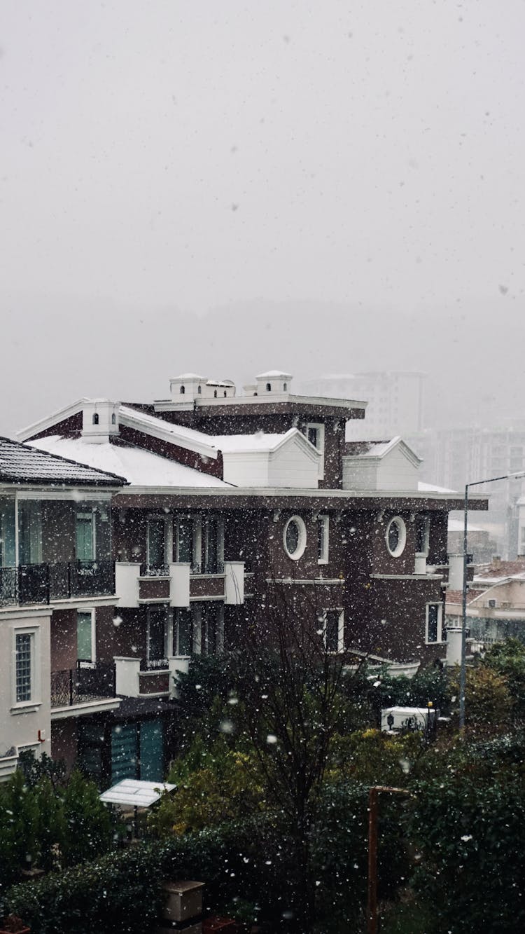 White And Brown House During Snowing