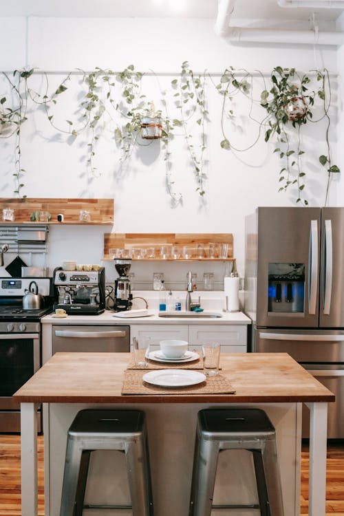 Kitchen and dining area in Scandinavian style located in cozy apartment