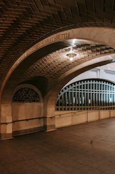 Interior of aged spacious arched passage decorated with geometric ornament leading to  subway shuttle in New York USA