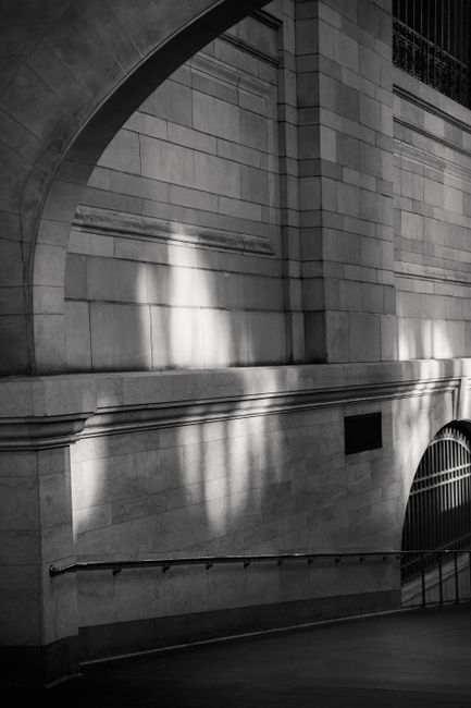Black and white of aged famous passage with arched pillars and brick walls located in Grand Central Terminal New York USA
