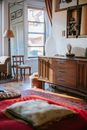 Old fashioned dresser near white wall in cozy bedroom