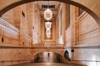Interior of arched passage in railway terminal with chandeliers