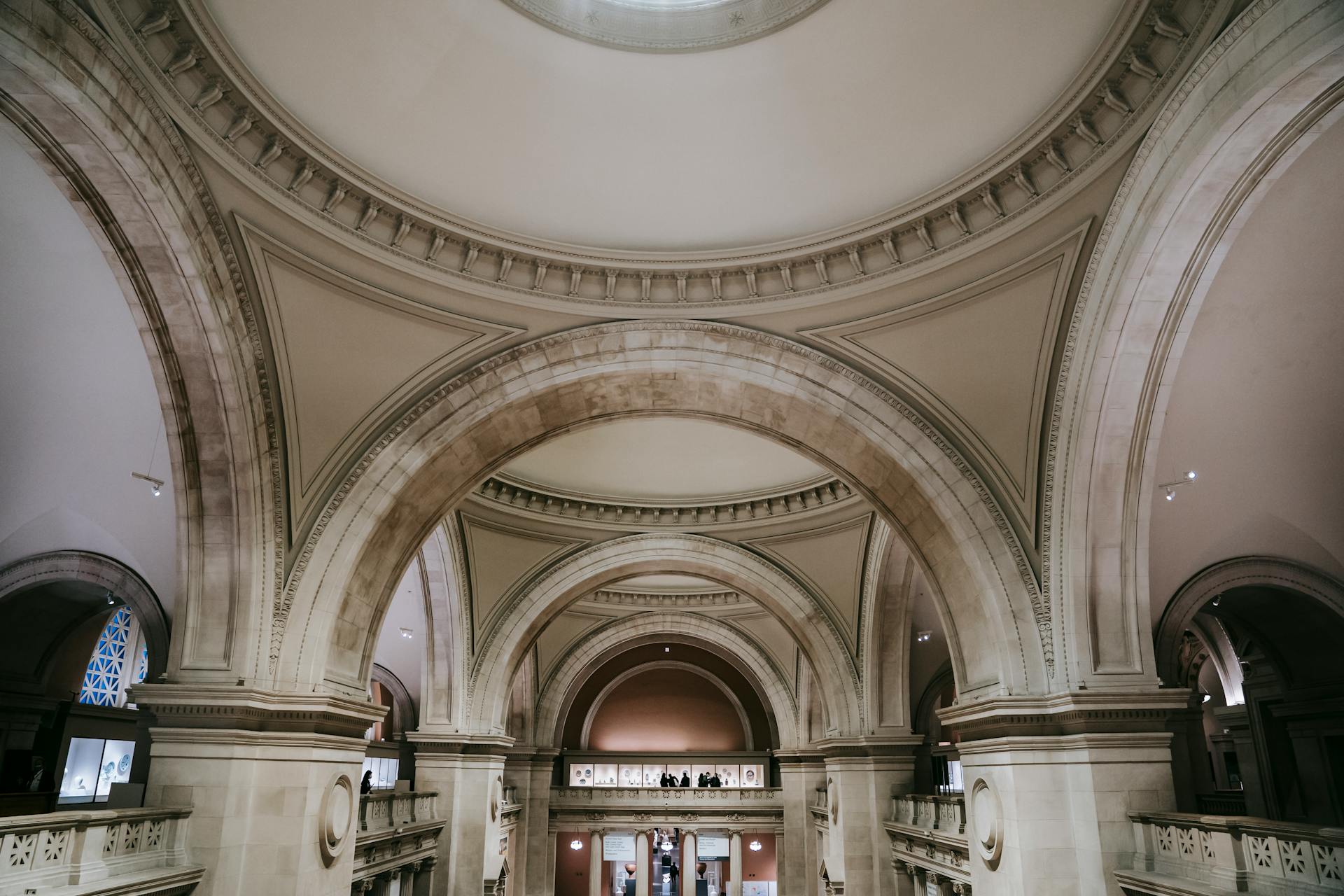 Interior of majestic spacious classic building with arched passages and ornamental elements on ceiling