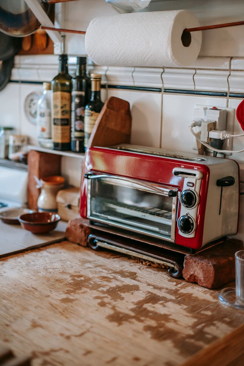 Compact toaster oven on kitchen counter - portable plug-in cooker for flats