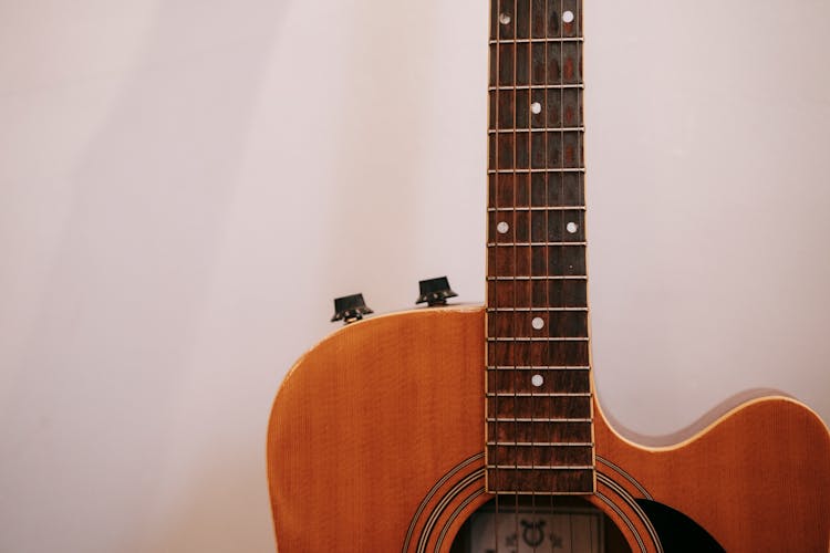 Neck Of Acoustic Guitar On White Background