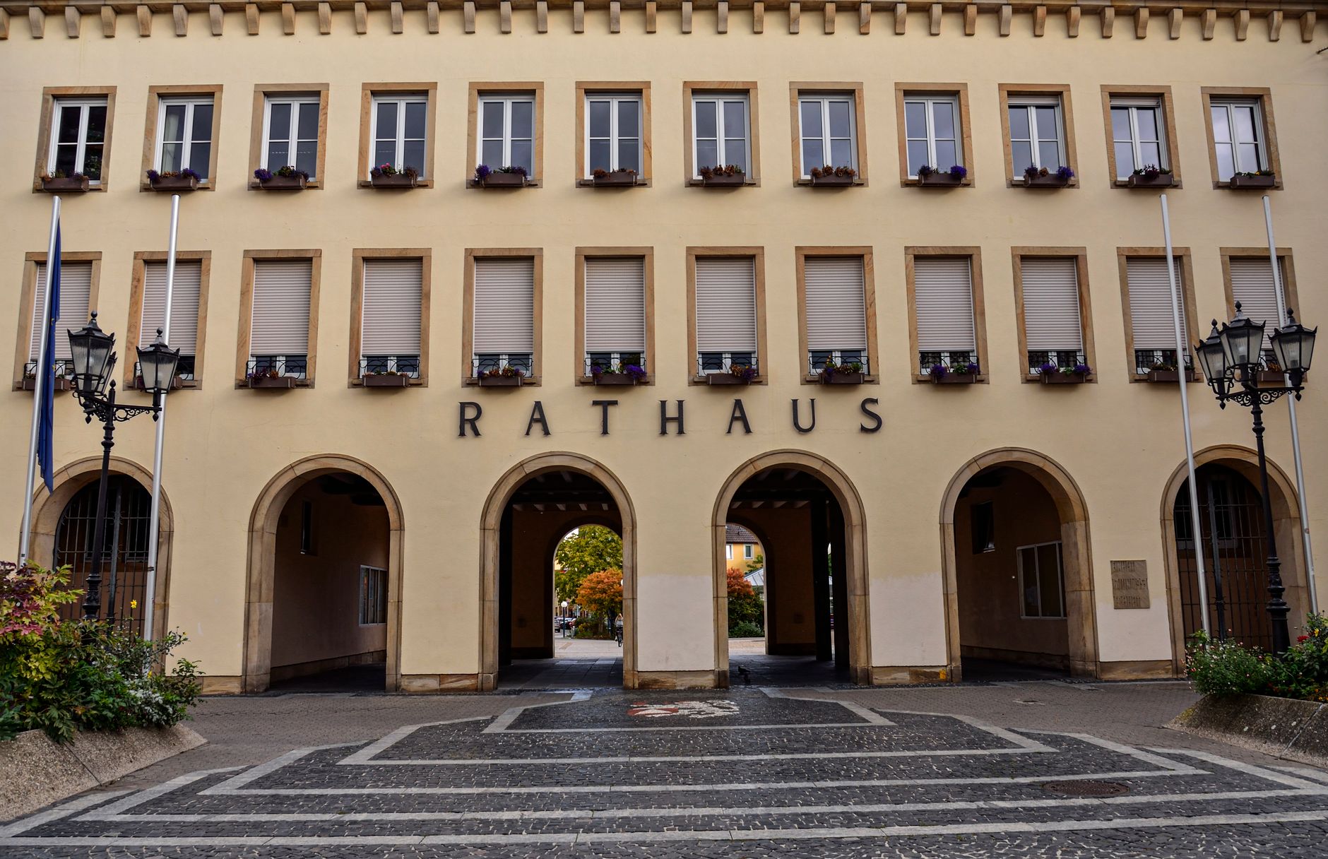 Exterior view of the Rathaus building in Frankenthal, Germany, showcasing its architectural arches and facade.