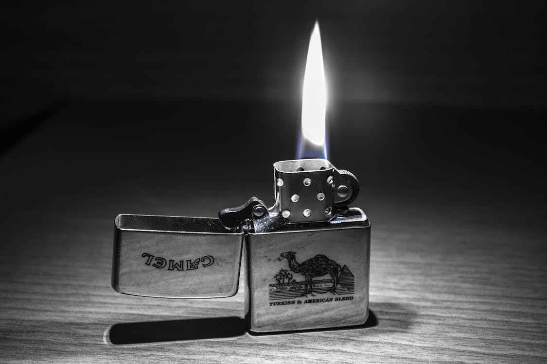 Grayscale Photography of Camel Flip Lighter