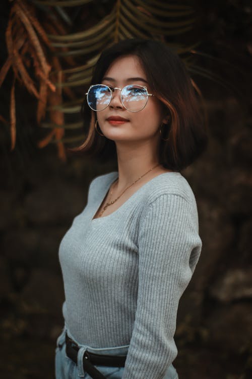 Woman in Blue Sweater Looking at Camera