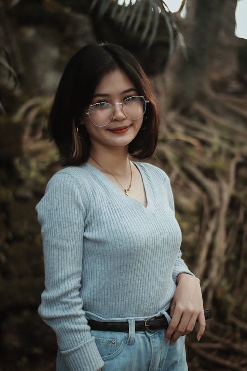 Woman in White V Neck Long Sleeve Shirt Wearing Black Framed Eyeglasses