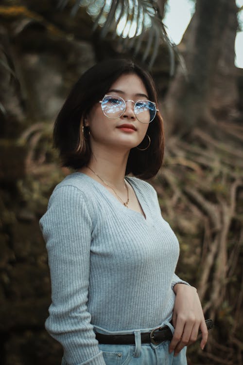 Woman in Blue Sweater Looking at Camera