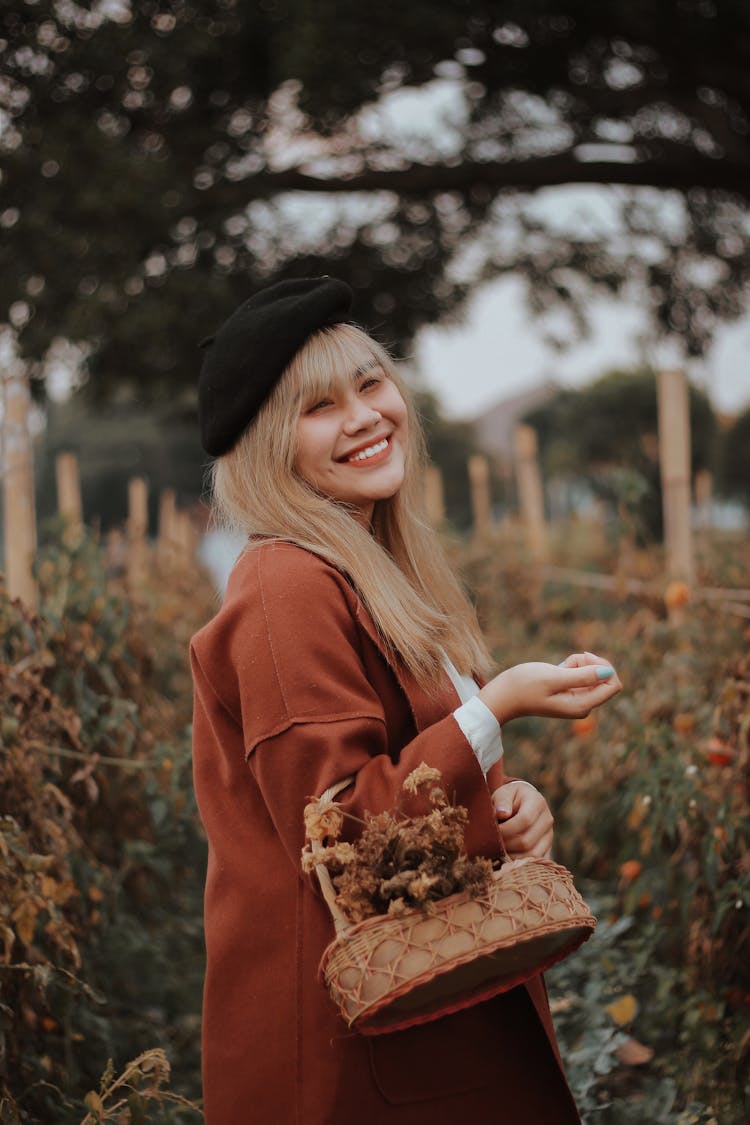 Happy Woman With Basket In Autumn Park