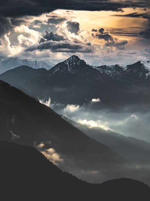 Free Captivating view of snow-capped mountains under dramatic skies, Lombardy, Italy. Stock Photo