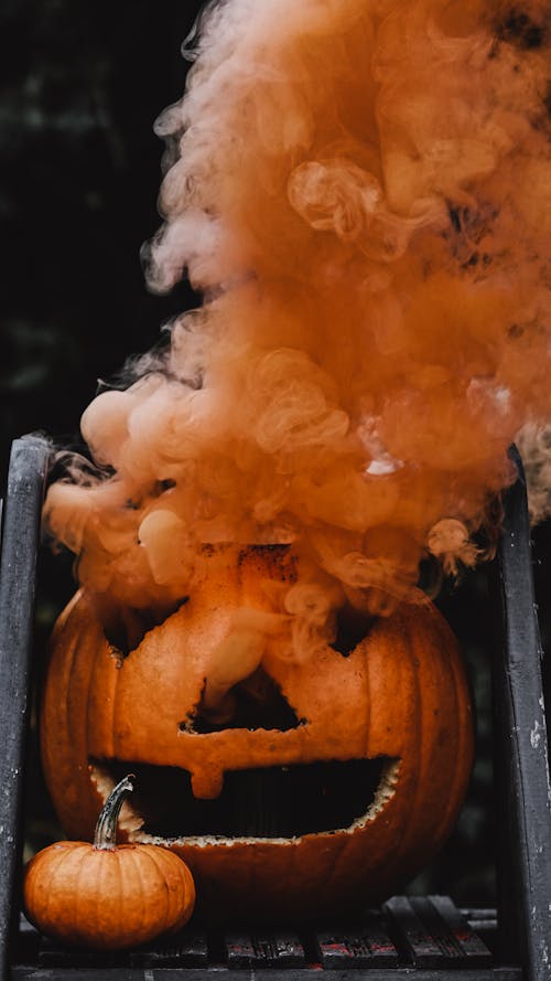 Free Orange Jack O Lantern With Orange Smoke Stock Photo