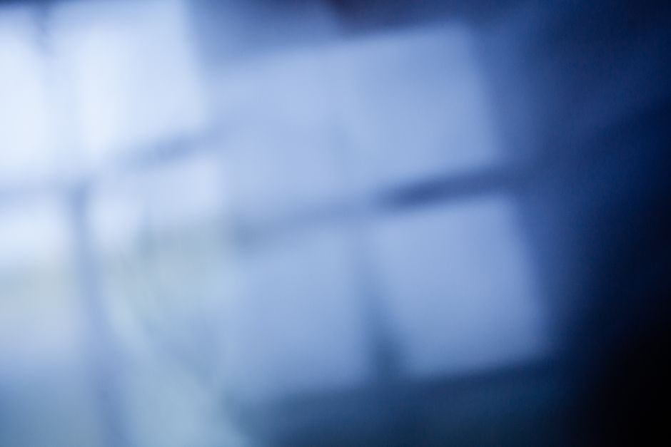 Defocused abstract background of blue lights with window reflecting on bright blurred surface