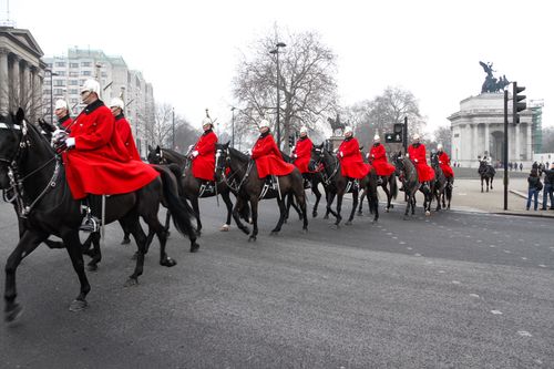 Free Horse Guards in red uniforms riding through London during a ceremonial parade. Stock Photo