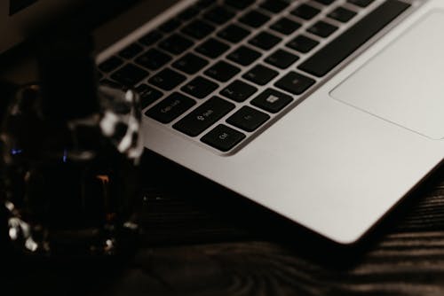 Free Silver Laptop on Black Wooden Table Stock Photo