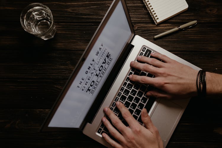 Top View Of Typing On A Laptop