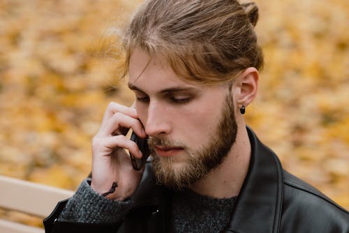 A Bearded Man Using a Smartphone