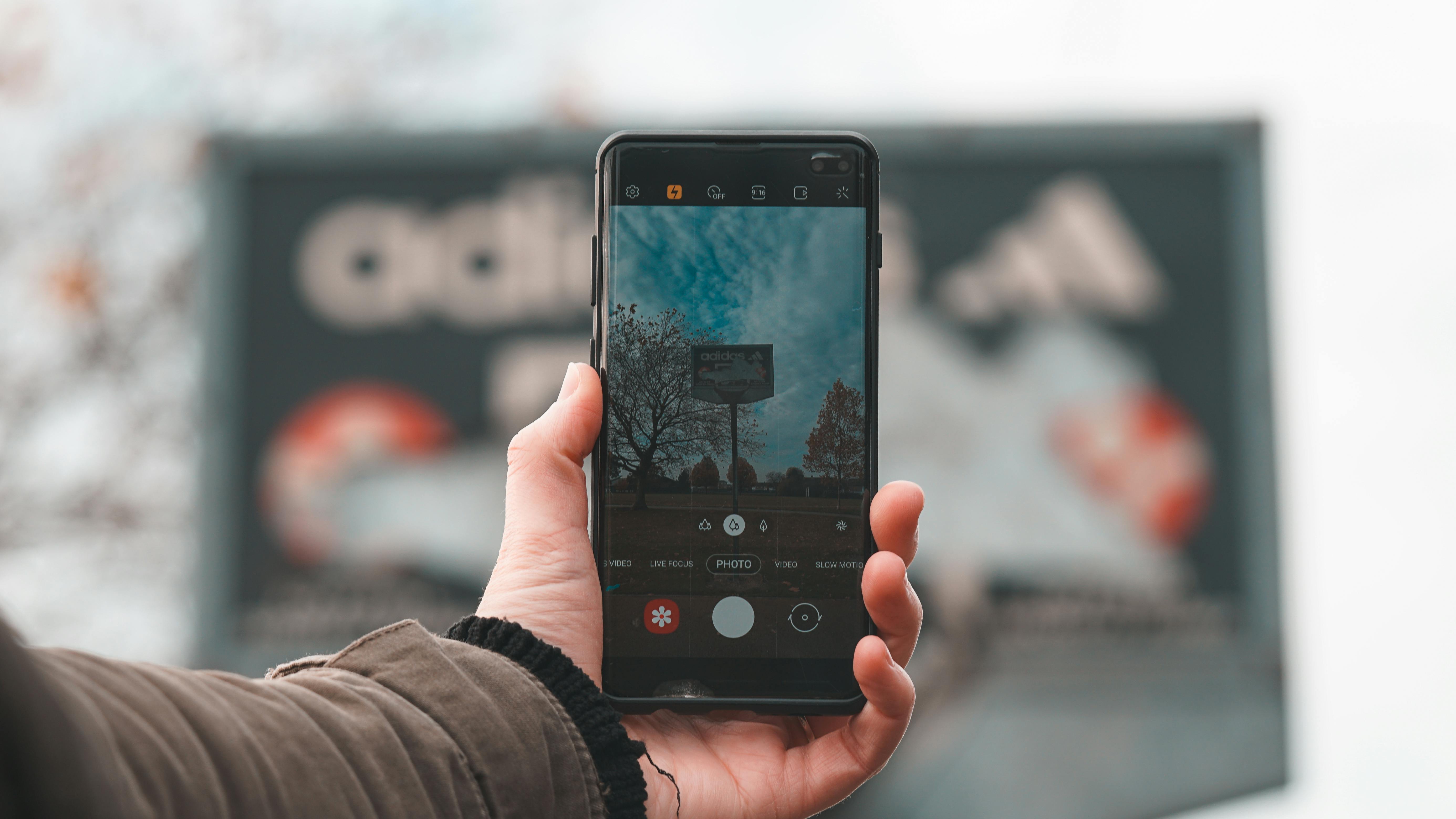 person holding black android smartphone