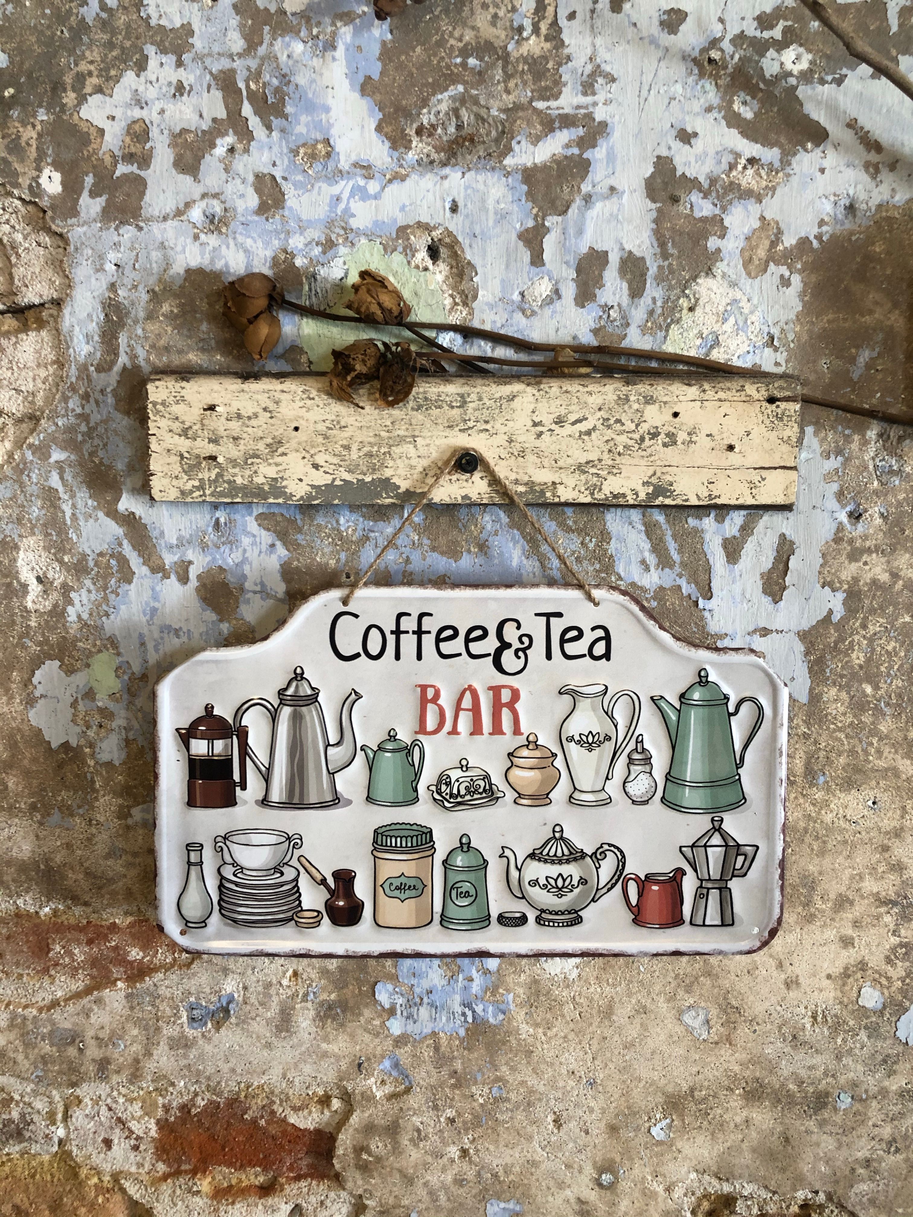 retro metal coffee sign mounted on a kitchen wall above a coffee bar