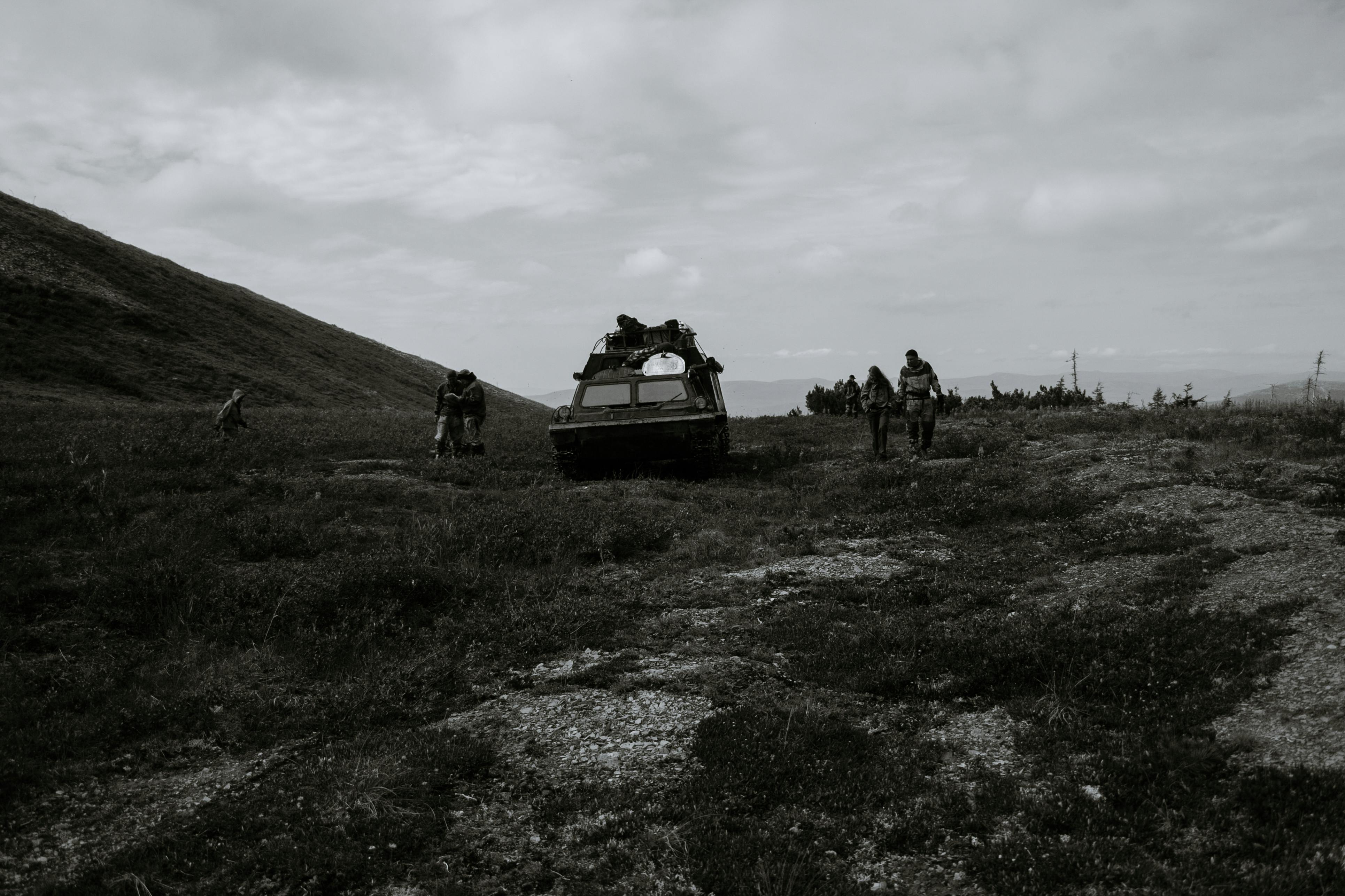 unrecognizable soldiers near tank during military training