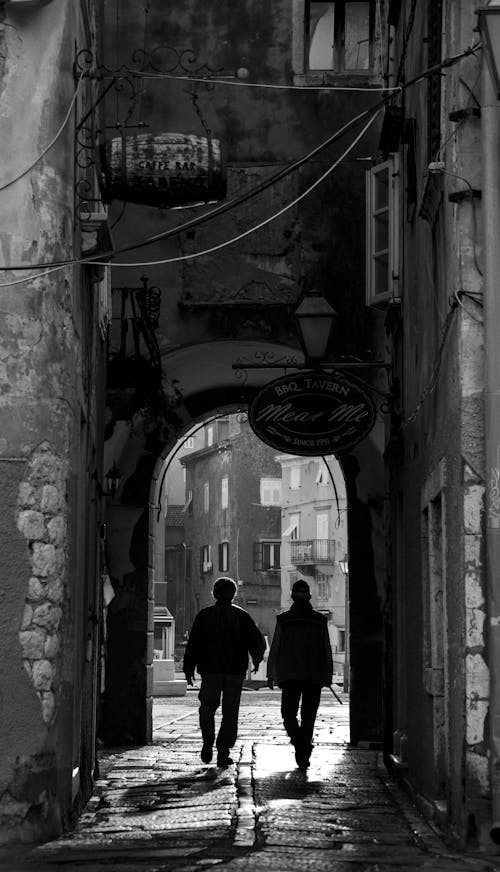 Silhouettes of Men on Alley