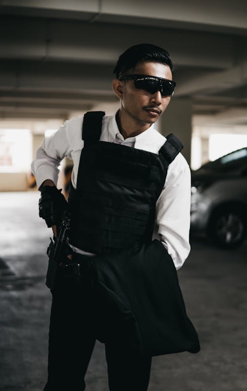 Man in White Dress Shirt and Black Bulletproof Vest