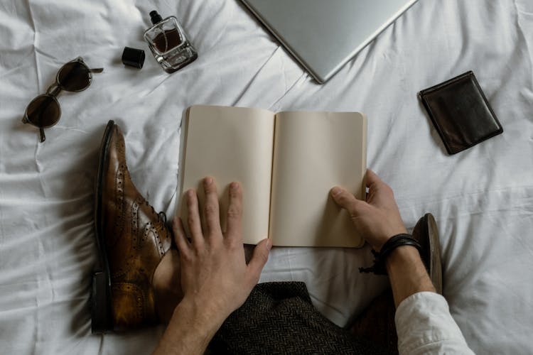 A Person Holding A Blank Book