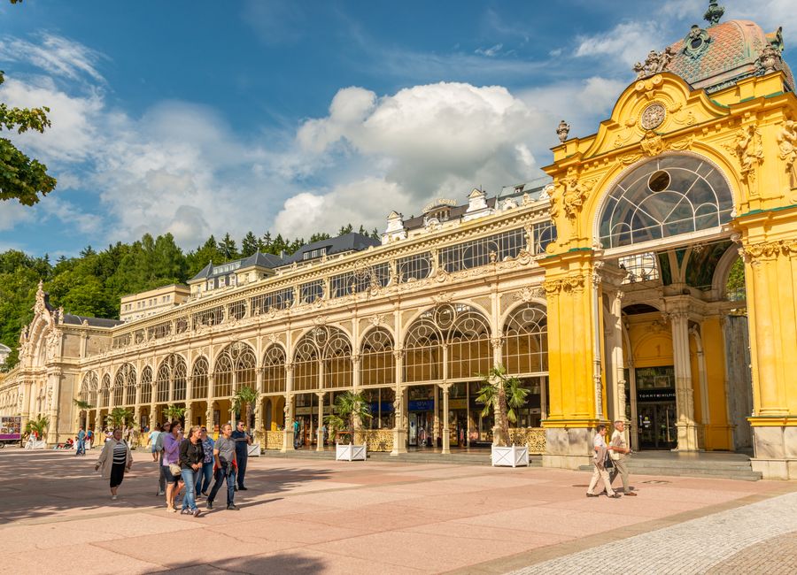 Beautiful historic colonnade in Marianske Lazne, Czech Republic, under a bright sky.