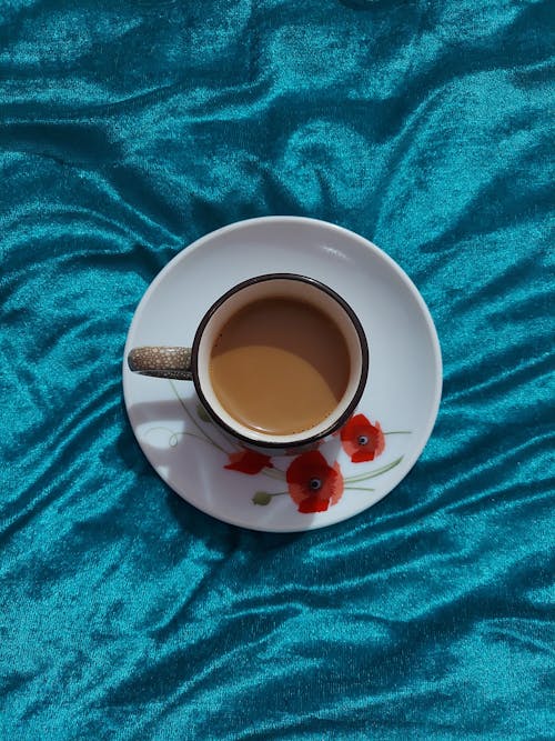 A Cup and a Saucer on a Blue Surface