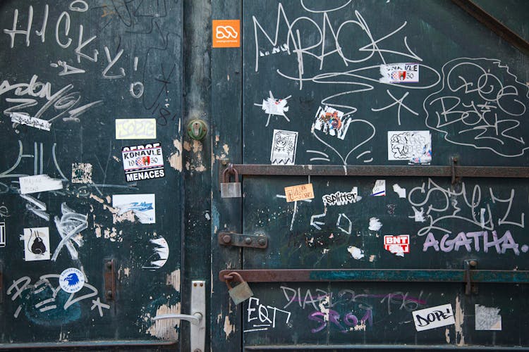 Shabby Door With Graffiti And Stickers