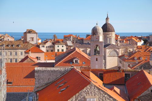 Free Old city of Dubrovnik in Croatia with small houses with red roofs and buildings near water in sunny summer day under blue cloudless sky Stock Photo