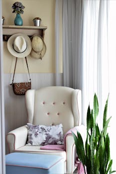 Elegant bedroom corner with a cozy armchair, natural light, and stylish decor.