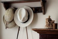White Fedora Hat on Brown Wooden Table