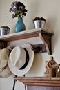 White and Blue Ceramic Vase on Brown Wooden Shelf