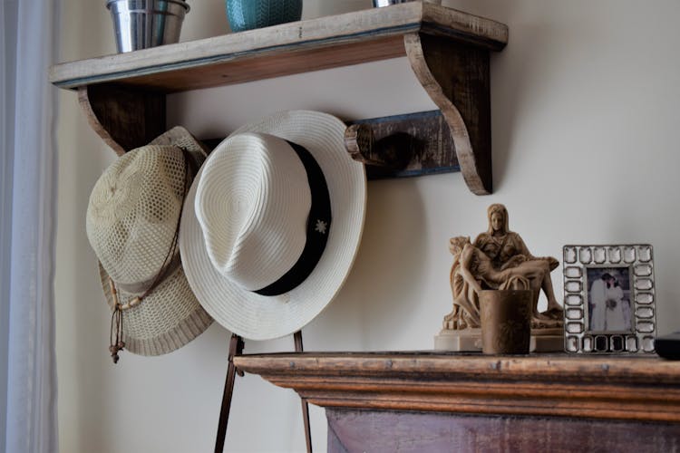 Sun Hats Hanging On Wooden Hat Rack On Wall